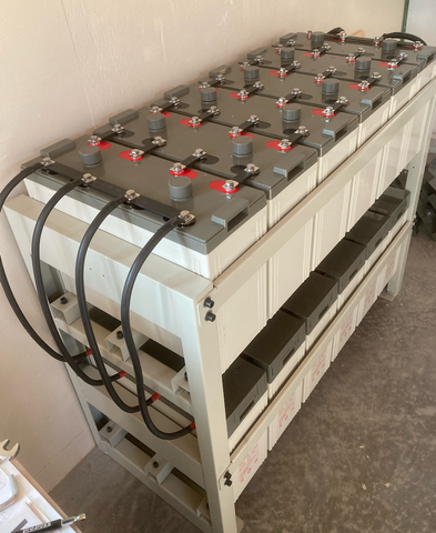 Rows of Valiant 2 Volt batteries on a stand with Cables and Busbars